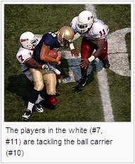 The players in the white (#7, #11) are tackling the ball carrier (#10)