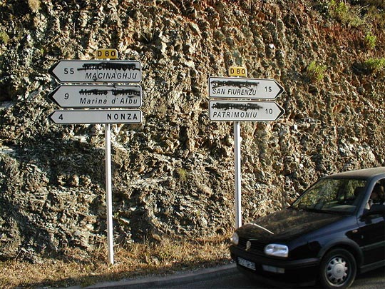 Bilingual road-signs, with French names crossed out