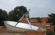 The Solar Bowl in Auroville, India, concentrates sunlight on a movable receiver to produce steam for cooking