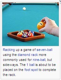 Racking up a game of seven-ball using the diamond rack more commonly used for nine-ball