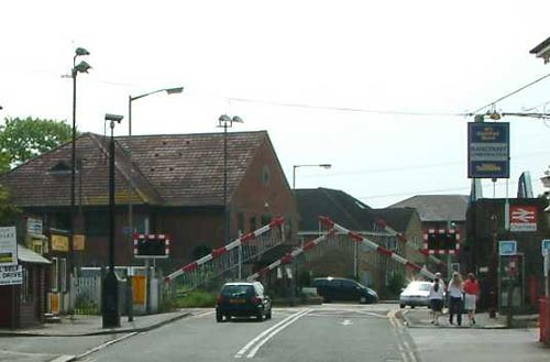 Four-quadrant gates at Chertsey, England. The gates are rising