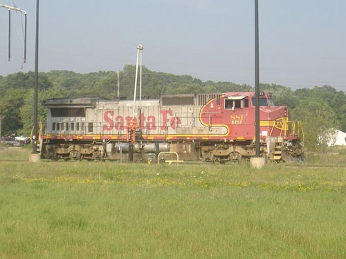 Santa Fe Dash 8 #881 is sitting at CN's Battle Creek fueling depot, displaying the modern interpretation of the company's classic red and silver "warbonnet" livery