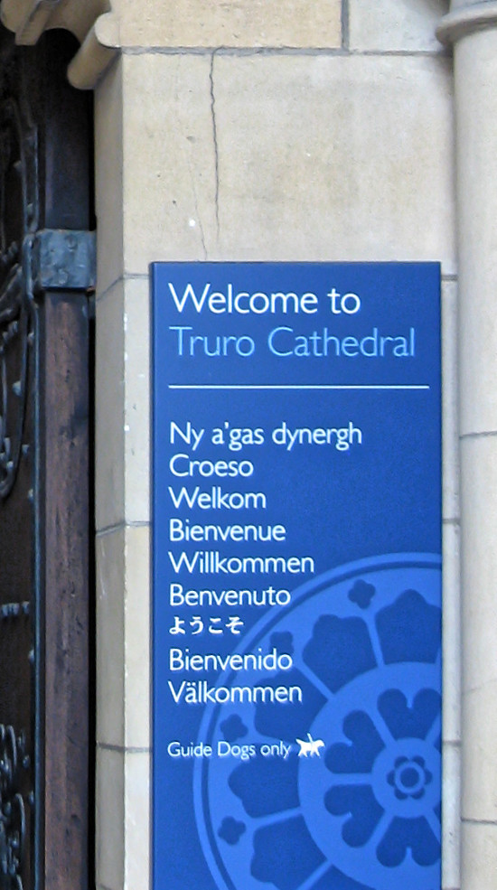 Welcome sign at Truro Cathedral in several languages, including Corni