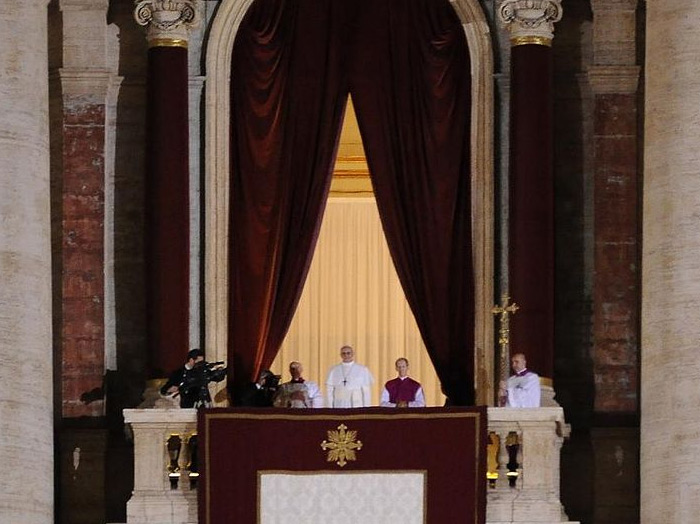 Francis appears to the public for the first time as pope at the balcony of St. Peter's Basilica, 13 March 2013